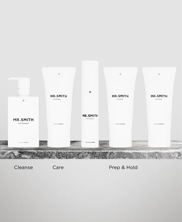 Set of skincare products labeled 'MR. SMITH' on a marble surface with a neutral background.