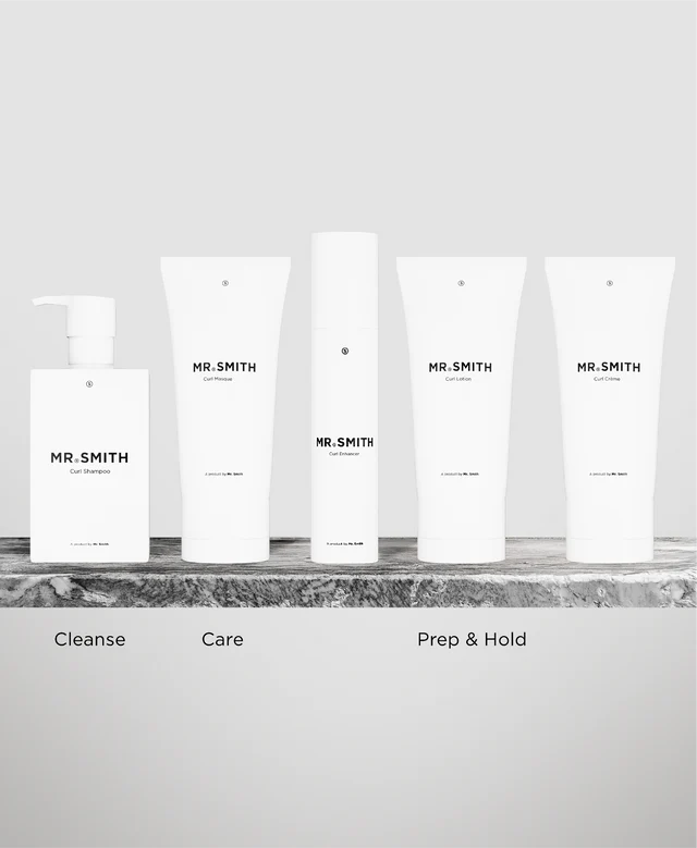 Set of skincare products labeled 'MR. SMITH' on a marble surface with a neutral background.