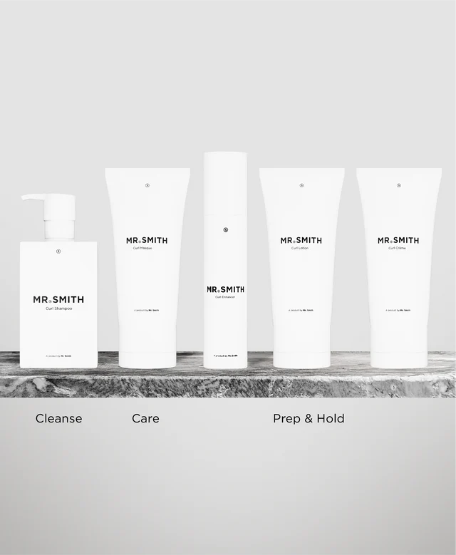 Set of skincare products labeled 'MR. SMITH' on a marble surface with a neutral background.