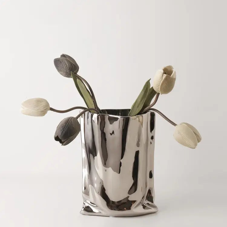 Silver vase with dried flowers on a white background