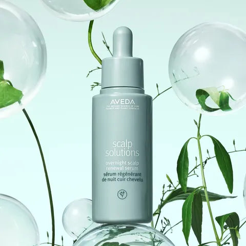 Aveda scalp solutions serum bottle with green leaves and bubbles in the background