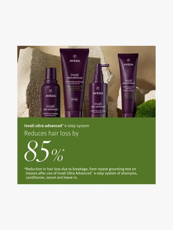 A promotional graphic for the Aveda Invati Ultra Advanced 4-step hair system, showing four dark purple bottles and tubes against a stone background, with a green text block below highlighting a 85% reduction in hair loss.