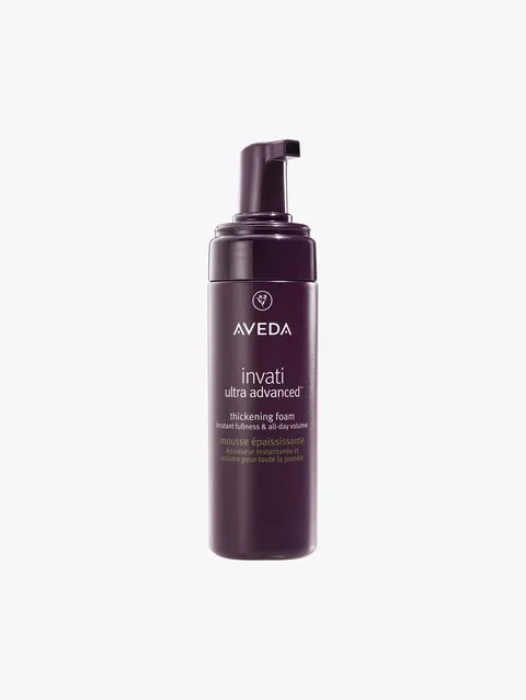 A bottle of Aveda Invati Ultra Advanced Thickening Foam on a light gray background.