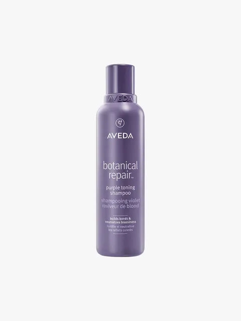 A bottle of Aveda Botanical Repair Purple Toning Shampoo on a light gray background.