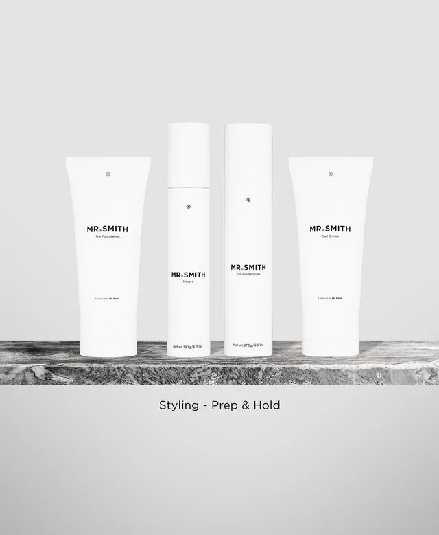 ThreeMR. Smith hair product bags on a marble surface with a white background