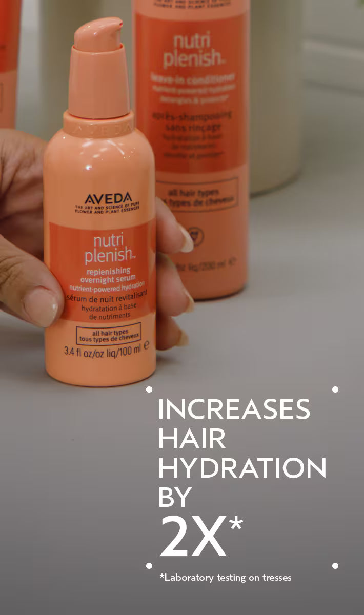 Aveda nutriplenish hair care product held by a hand with text highlighting hair hydration benefits.