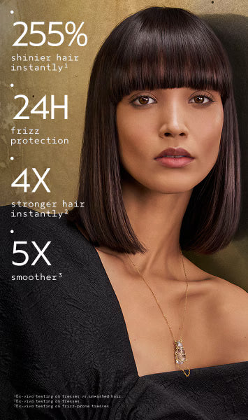 A woman with a straight, shoulder-length dark brown bob haircut and blunt bangs is shown against a warm beige background. Large white text on the left lists hair benefits: '255% shinier hair instantly', '24H frizz protection', '4X stronger hair instantly', and '5X smoother'.