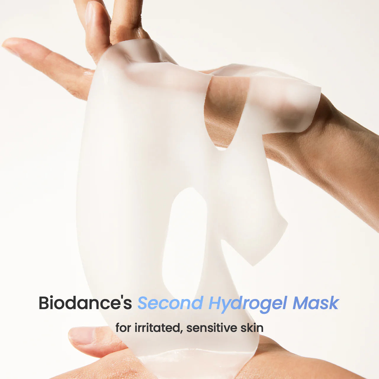 Biodance's Second Hydrogel Mask being held between two hands on a white background