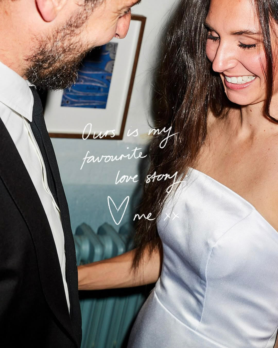 Couple in formal attire with text 'Ours is my favourite love story' on a blurred indoor background