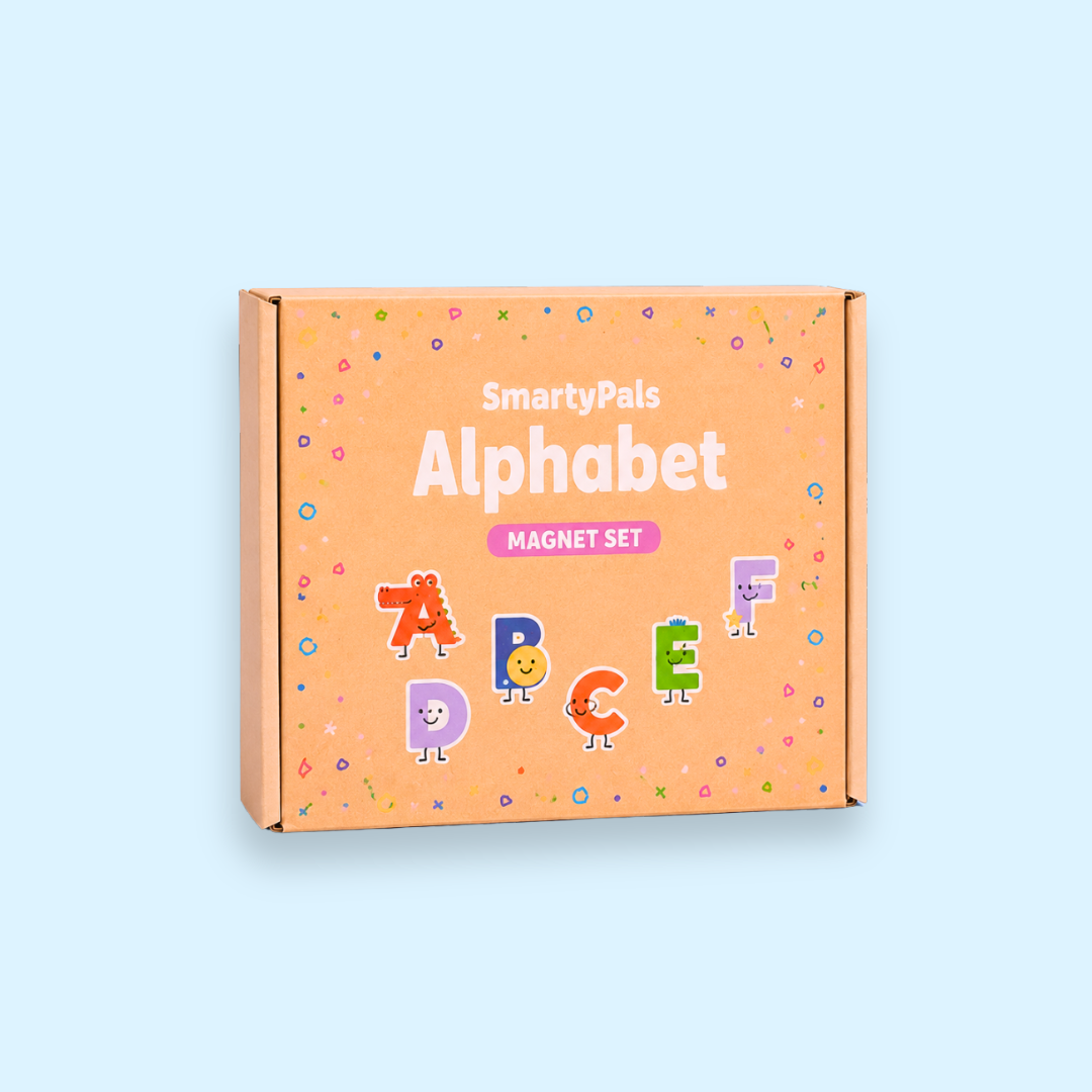 An orange cardboard box for a 'SmartyPals Alphabet Magnet Set' on a light blue background. The box features colorful cartoon letters and confetti details.