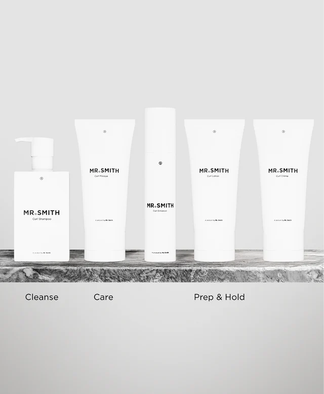 Set of skincare products labeled 'MR. SMITH' on a marble surface with a neutral background.