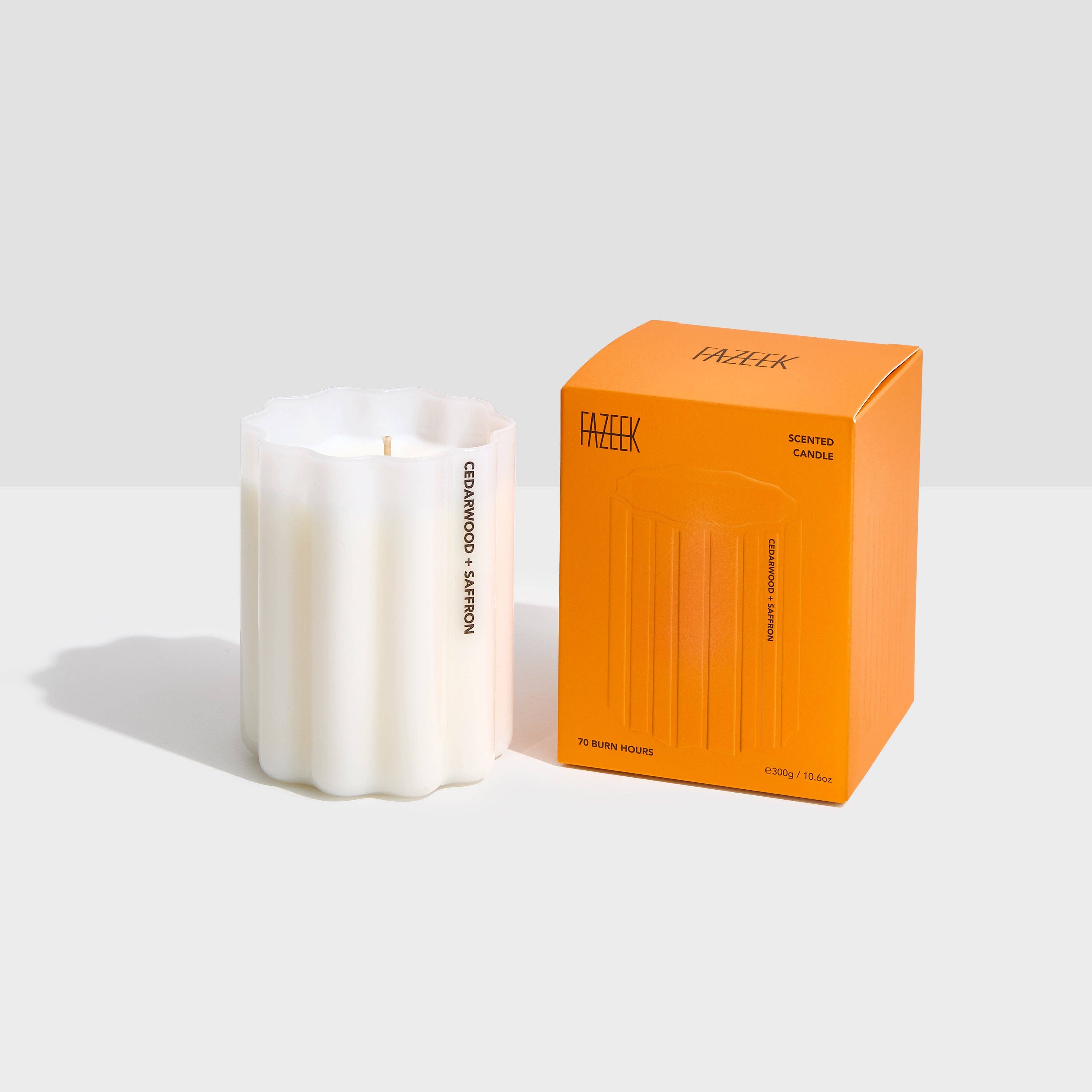 White candle with an orange box labeled 'FAZEK' on a light gray background