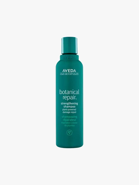Aveva Botanical Repair Strengthening Shampoo in a teal green bottle with a matching cap, centered on a light gray background.