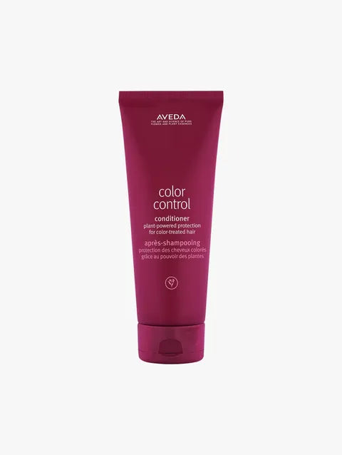 A tube of Aveda Color Control Conditioner in a deep magenta-purple color, shown against a plain light gray background.