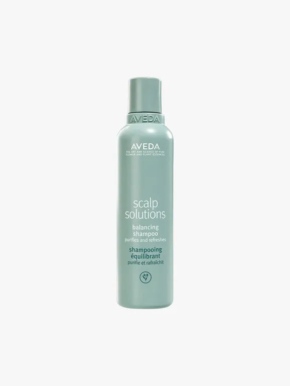 Aveva Scalp Solutions Balancing Shampoo in a light sage green bottle, centered on a light gray background.