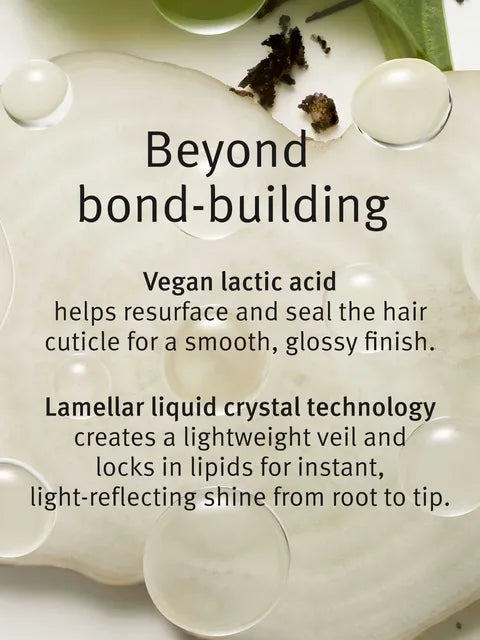 A close-up beauty product shot showing a glossy white or off-white hair treatment or mask with text reading 'Beyond bond-building' and descriptive copy about vegan lactic acid and lamellar liquid crystal technology. No person, animal, or real environment is present, so this is Product/Packaging rather than Lifestyle.