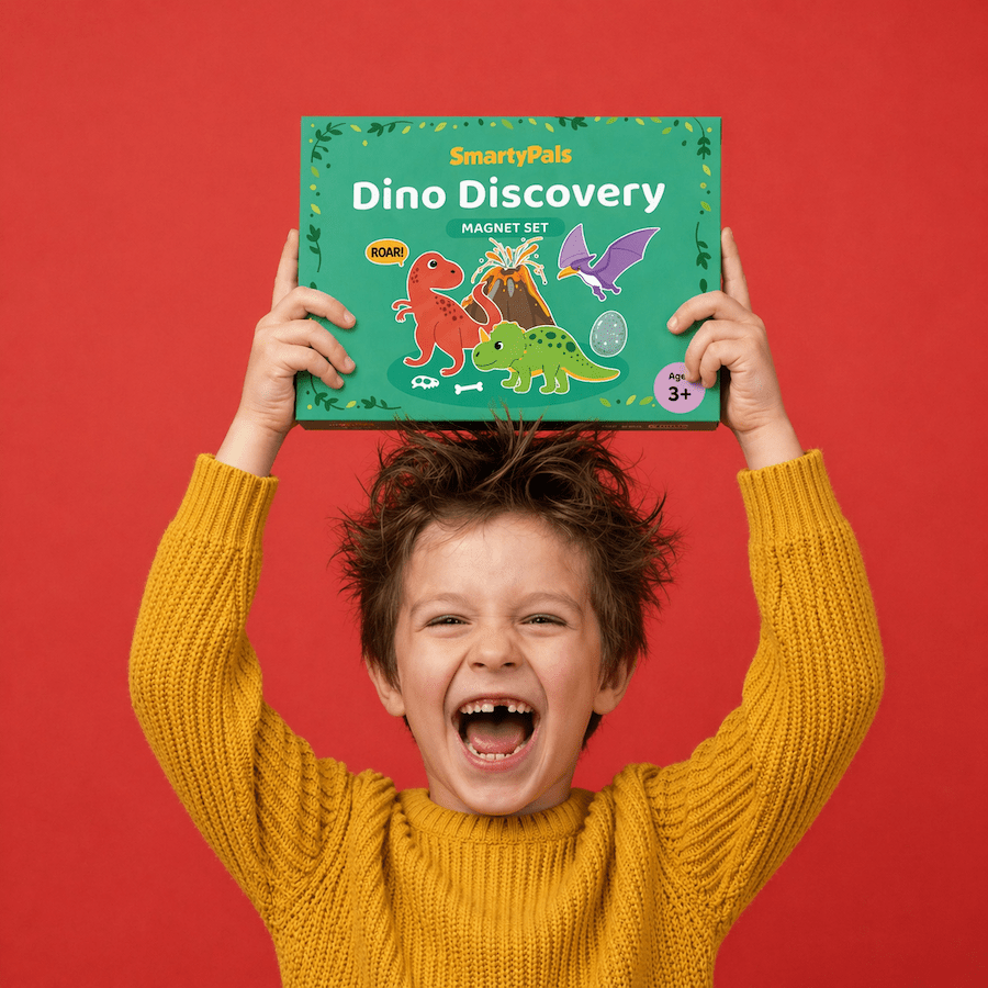 Child holding up a 'Dino Discovery' magnet set against a red background