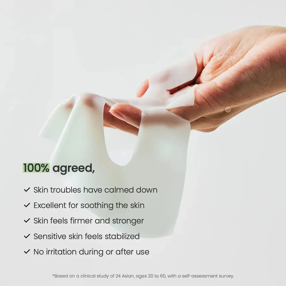 Hand holding a white sheet with text about skin benefits on a light gray background