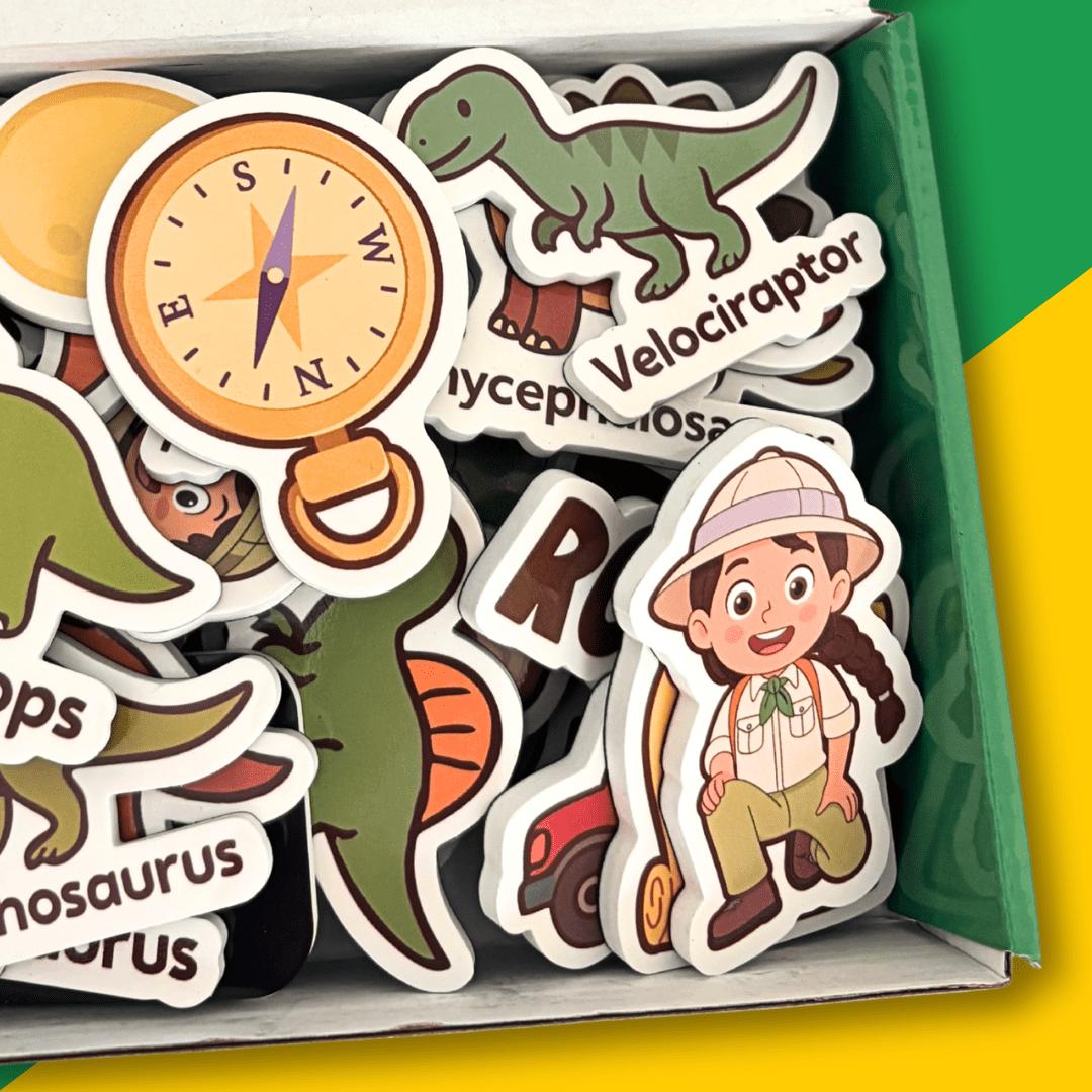 A collection of colorful dinosaur and explorer-themed die-cut stickers displayed inside an open box. The stickers feature cartoon illustrations including a green T-Rex, a compass, a child explorer character, and partial dinosaur names like 'Velociraptor' and 'Dinosaur'.