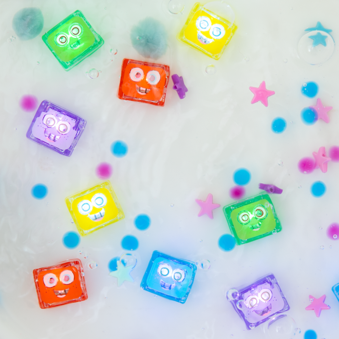 Colorful cassette tape-shaped ice cubes with faces on a white background