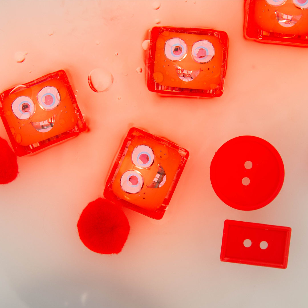 Red cassette tapes with face-like designs on a pink background