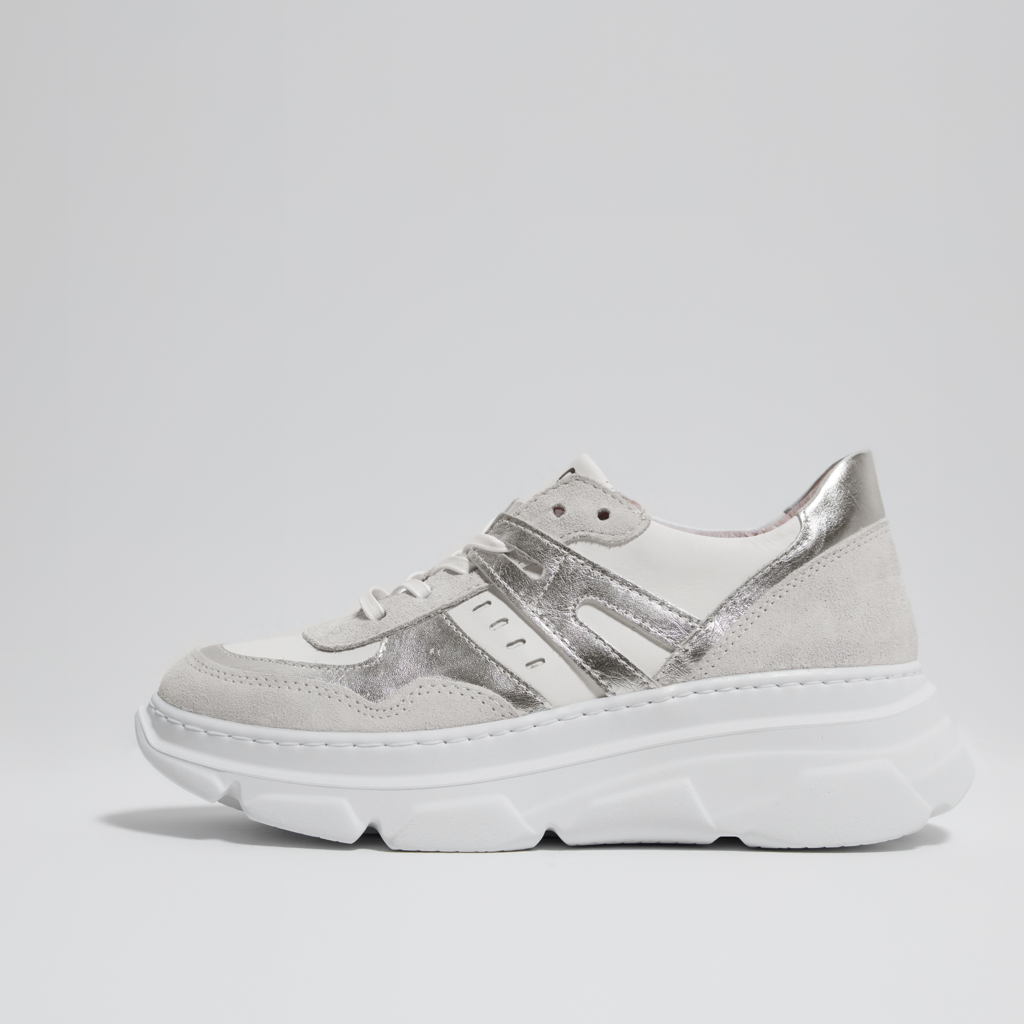 A pair of white, silver, and gray casual sneakers made of leather with a thick rubber outsole, designed and made in Italy.
